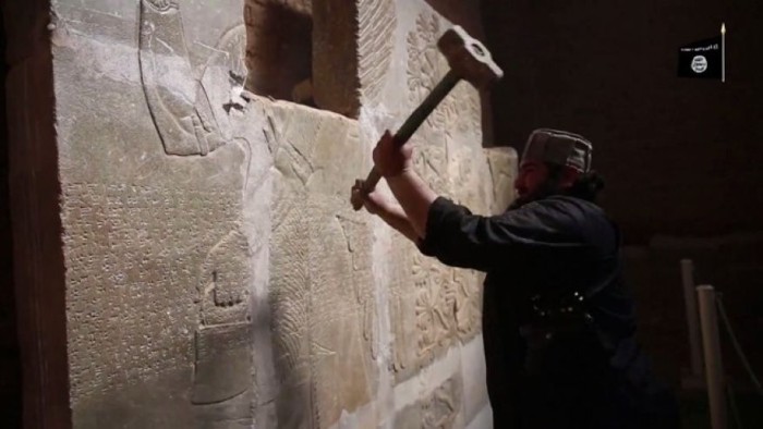 April 11, 2015: In this image made from video posted on a militant social media account affiliated with the Islamic State group purports to show a militant taking a sledgehammer to an Assyrian relief at the site of the ancient Assyrian city of Nimrud, which dates back to the 13th century B.C., near the militant-held city of Mosul, Iraq. The destruction at Nimrud, follows other attacks on antiquity carried out by the group now holding a third of Iraq and neighboring Syria in its self-declared caliphate. The attacks have horrified archaeologists and U.N. Secretary-General Ban Ki-moon, who last month called the destruction at Nimrud "a war crime." (Militant video via AP)